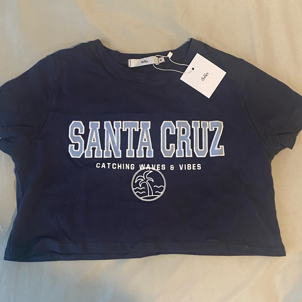 New Blue cropped Santa Cruz tee from Adika, new with tags, perfect condition, M